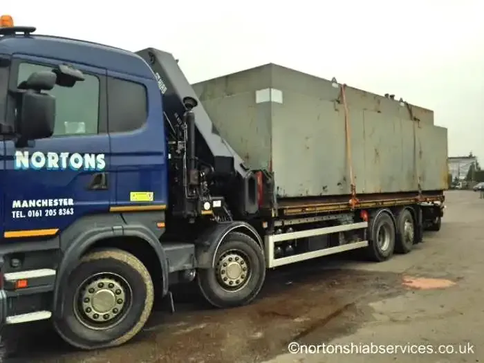 A weathered green fuel tank strapped down on a Nortons eight wheel rigid