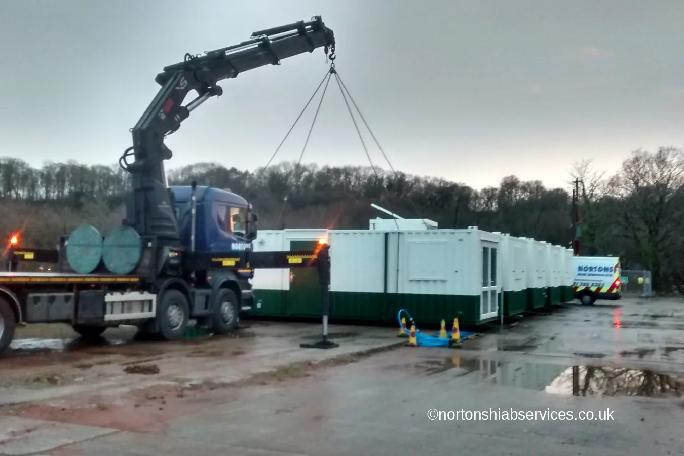 A Nortons hiab setting out the first green and white welfare cabins at Caernarfon