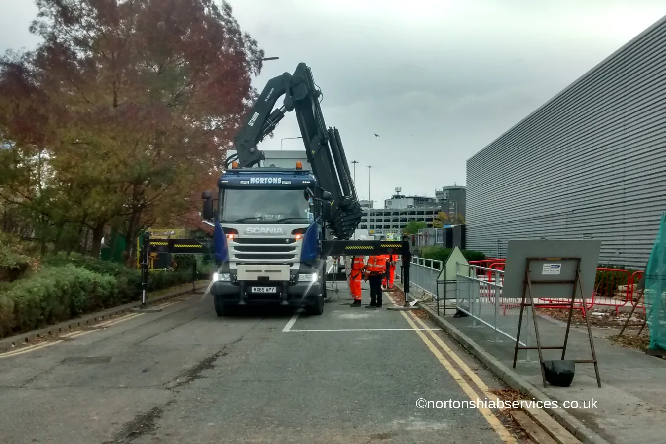 A Nortons hiab lorry set up on a university service road in Manchester