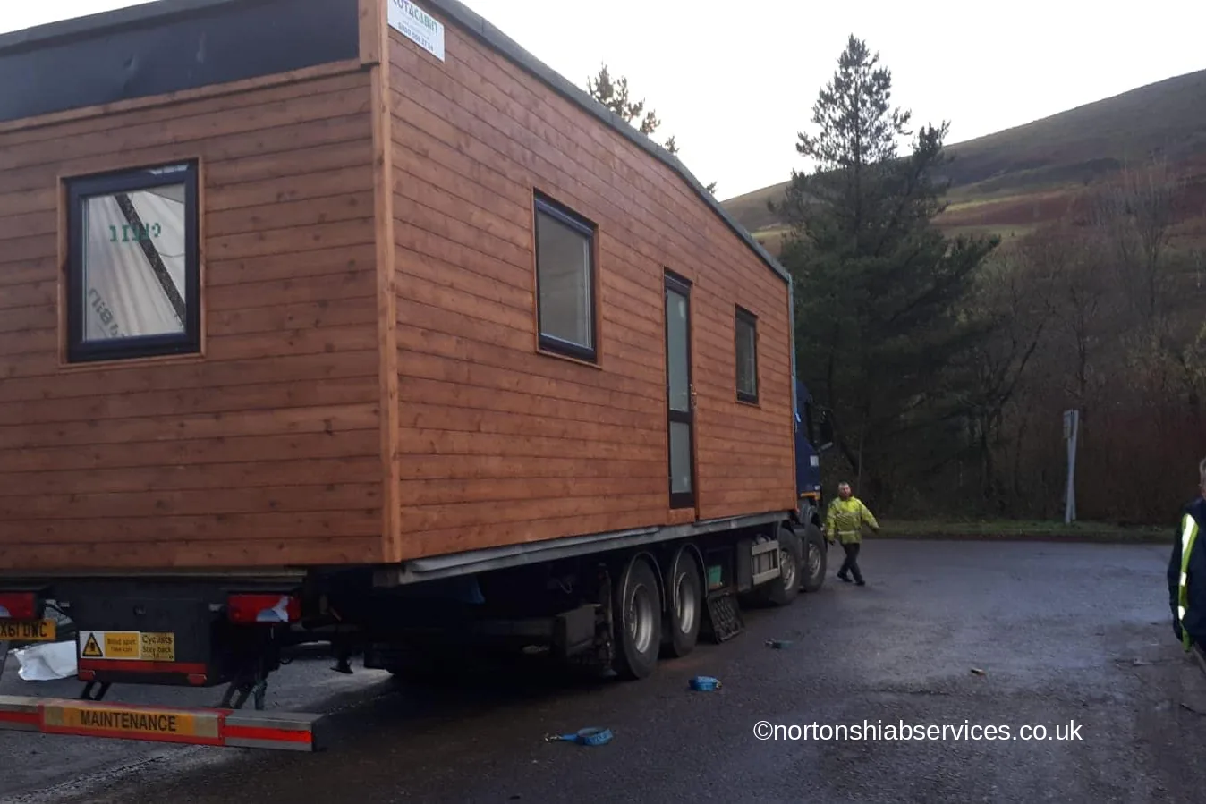 A cedar clad modular classroom on a Nortons trailer at a hillside site