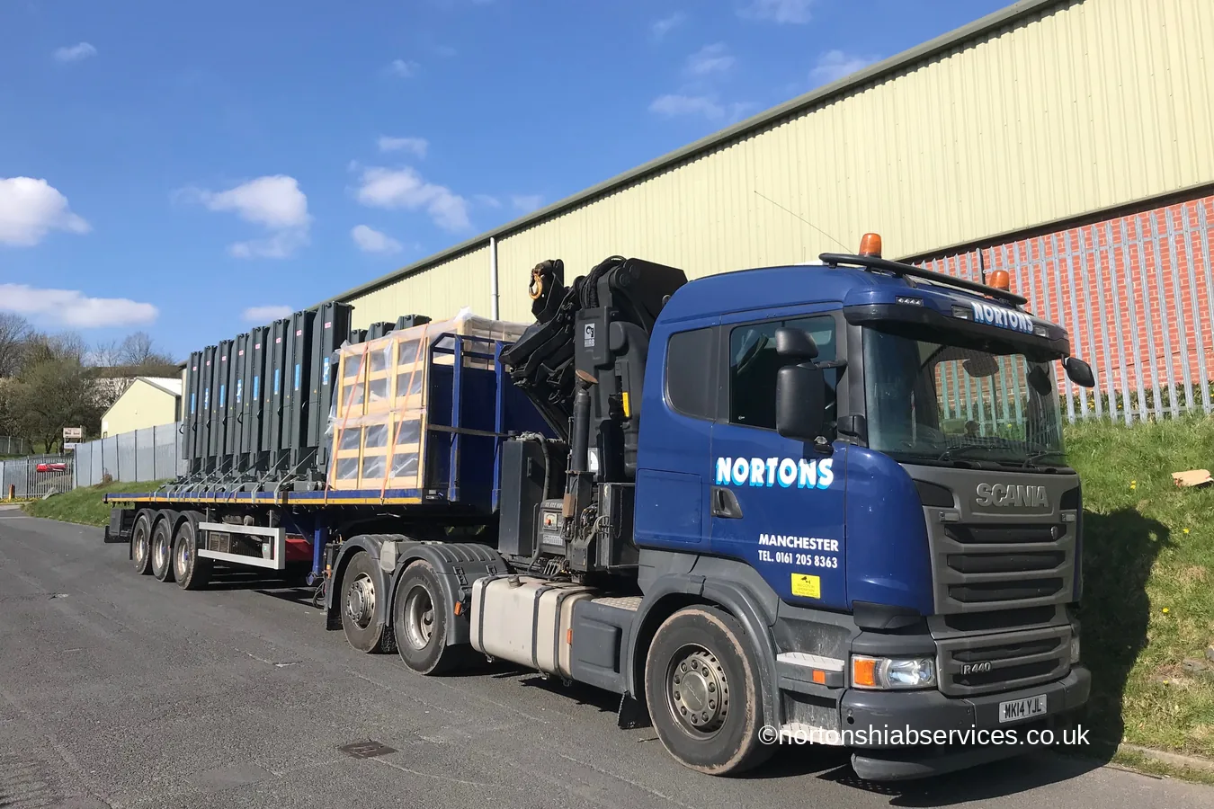 A Nortons wagon and drag loaded with crated garage vehicle lifts for a run to Somerset
