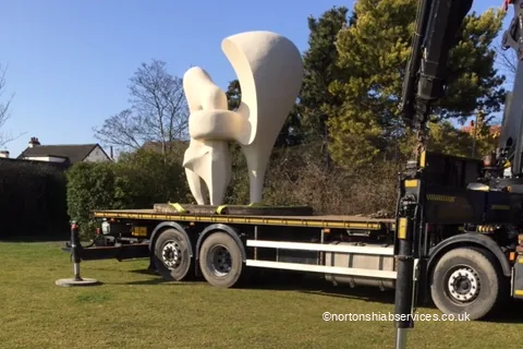 A large sculpture roped down on the bed of a Nortons hiab lorry at Southport