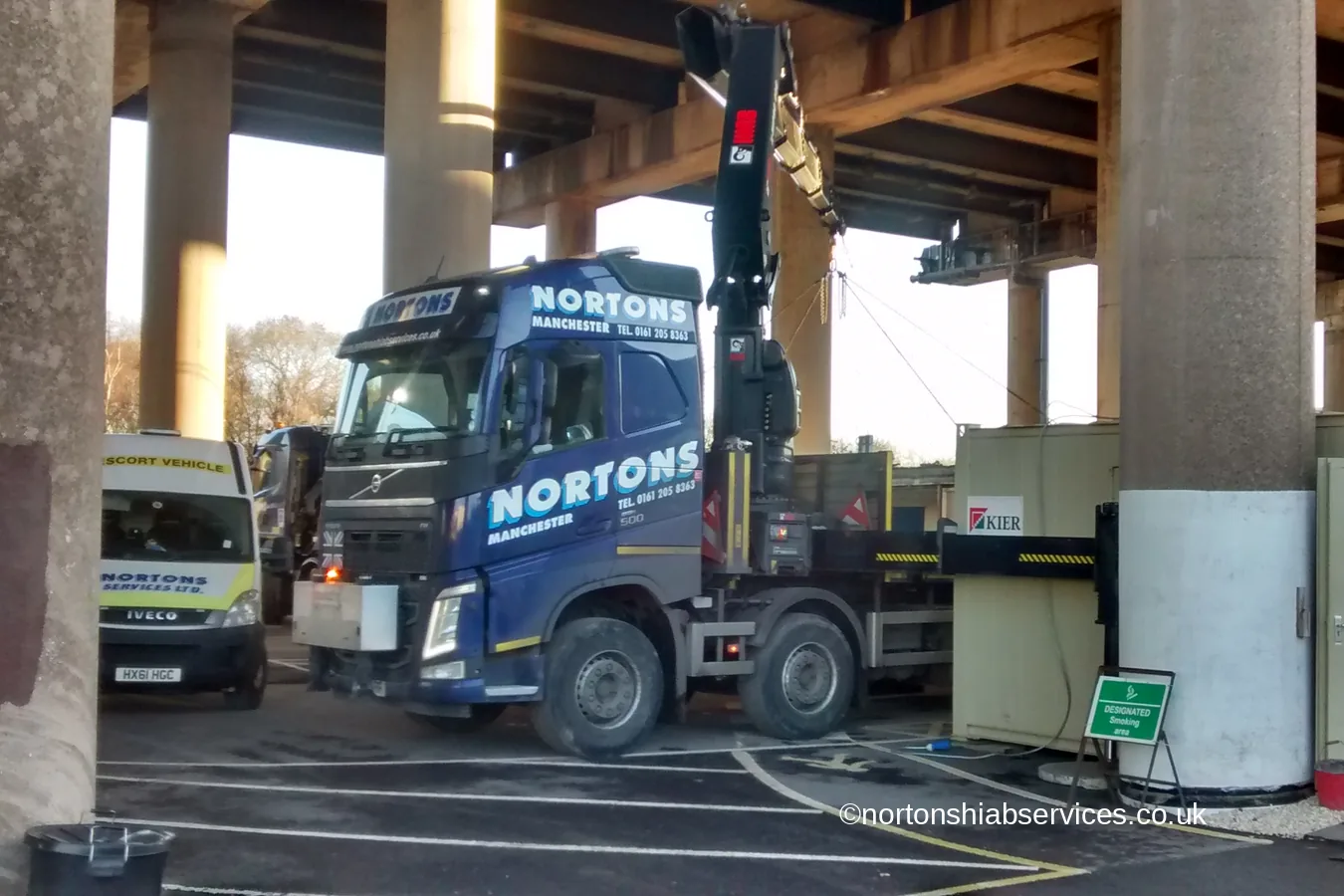 A Nortons hiab working between the piers beneath a motorway viaduct