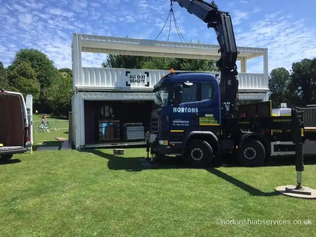 A Nortons hiab lorry delivering festival infrastructure on the grass at Brighton