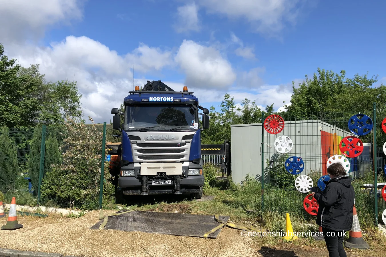 A Nortons hiab set up outside Carrbrook community centre