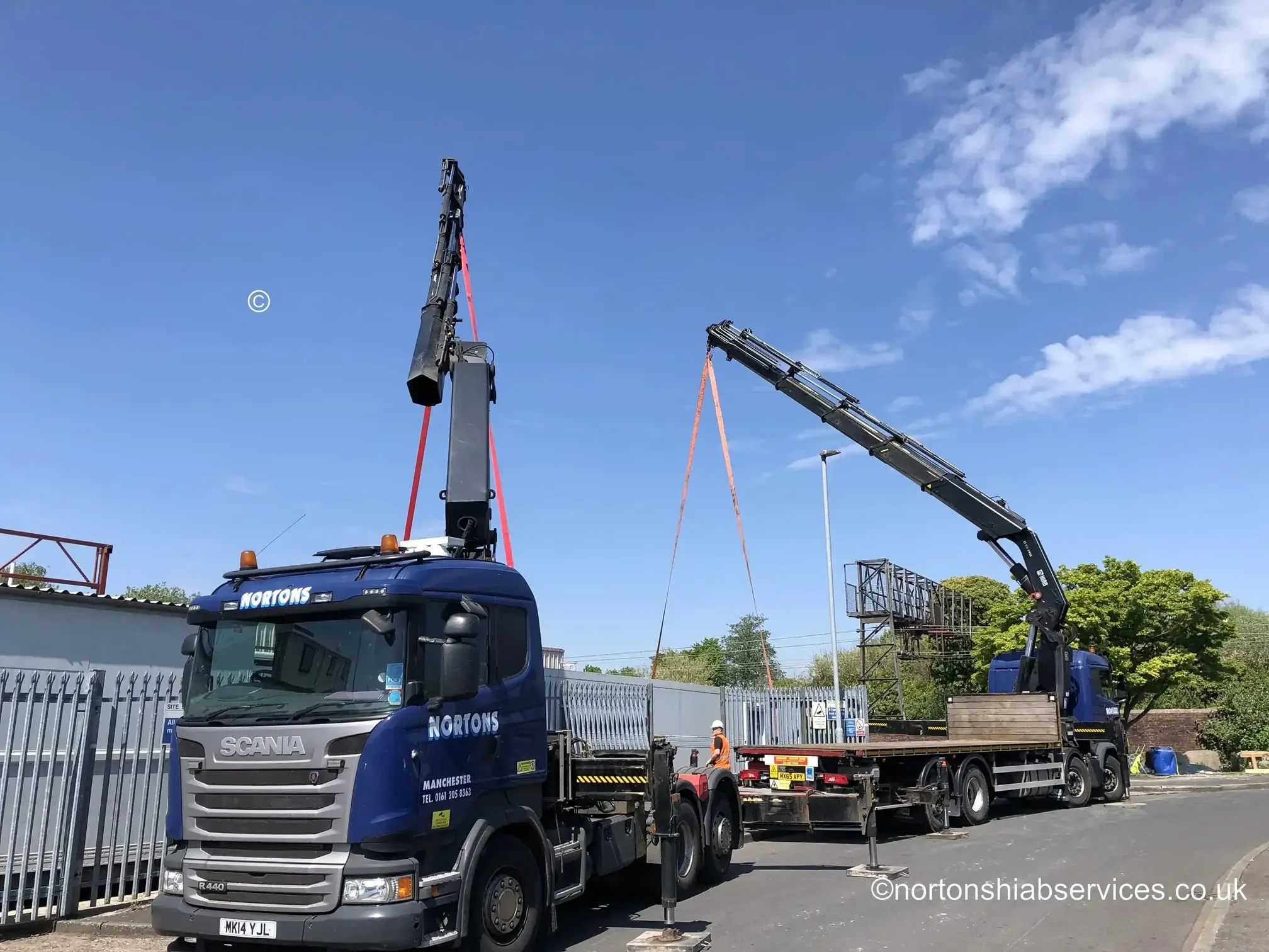 Two Nortons hiab cranes dual lifting a fourteen tonne freezer unit