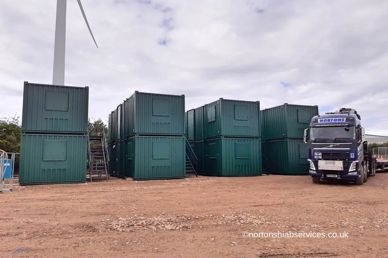 Double stacked green site cabins built by Nortons at Kings Dyke crossing near Peterborough