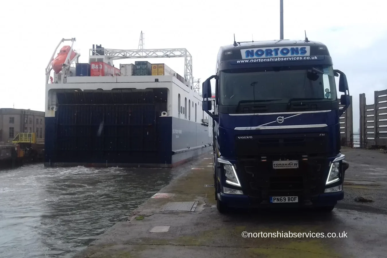 A Nortons hiab unit on the quay at Liverpool docks with a roll-on ferry stern door open