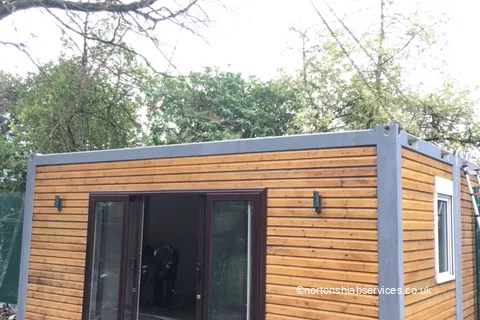 A timber-clad modular classroom placed on site at a Salford school