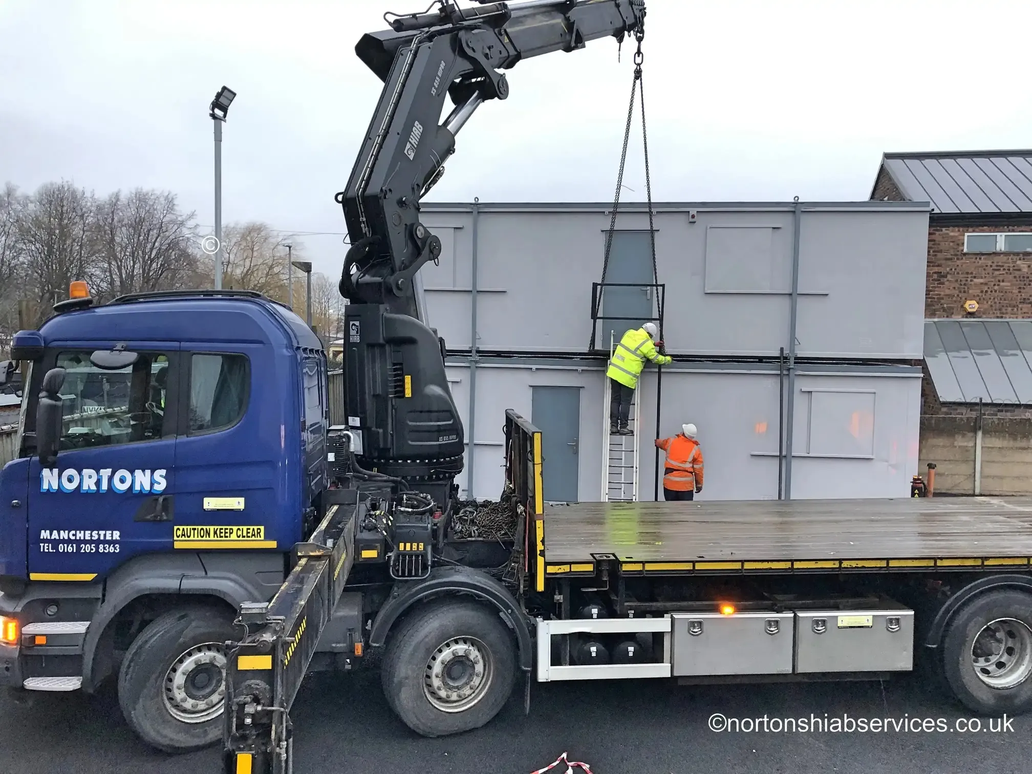 Nortons hiab delivering the first unit of a double portable cabin set-up