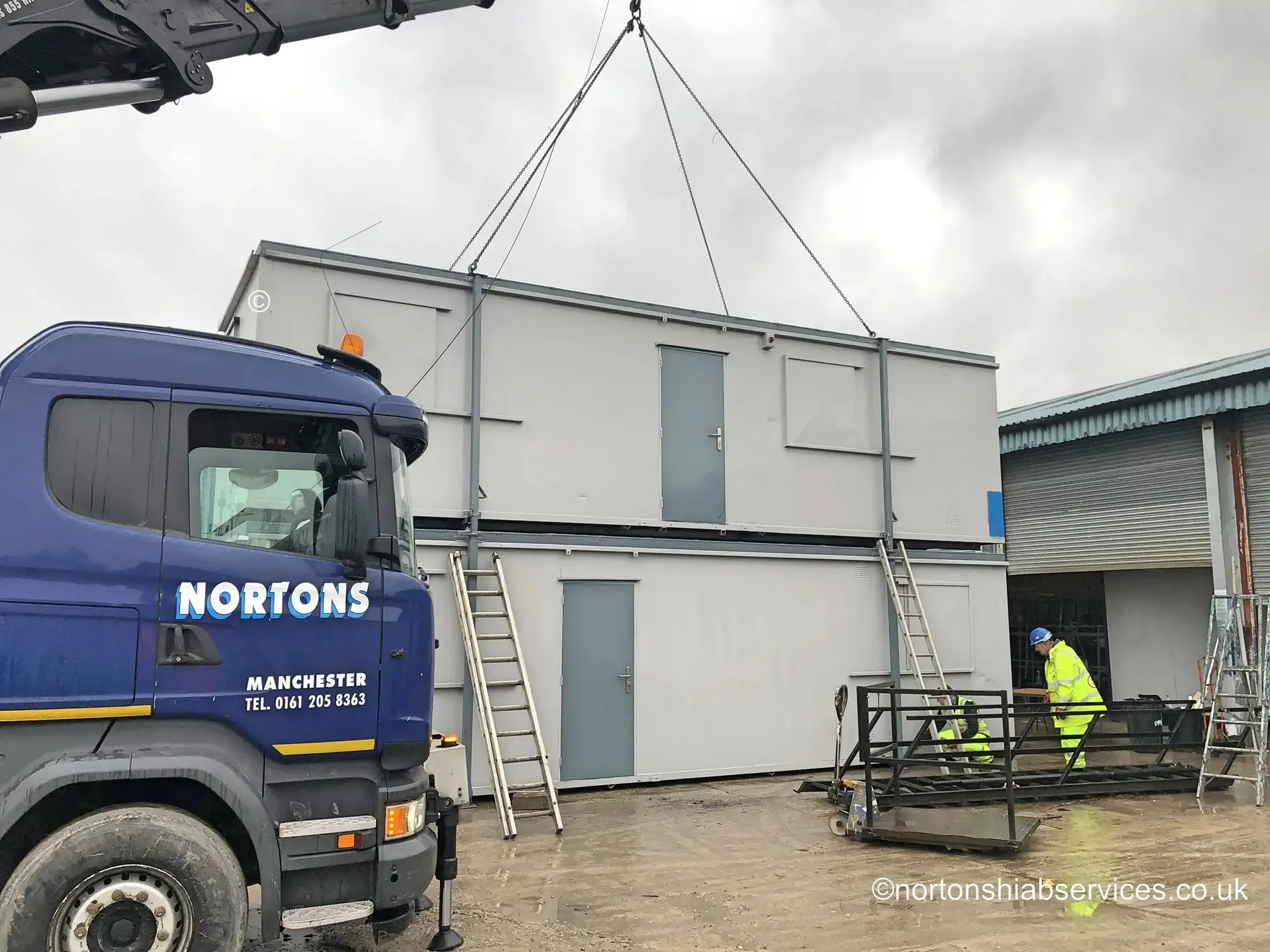 The upper unit of a double stacked portable cabin set-up landed by a Nortons hiab