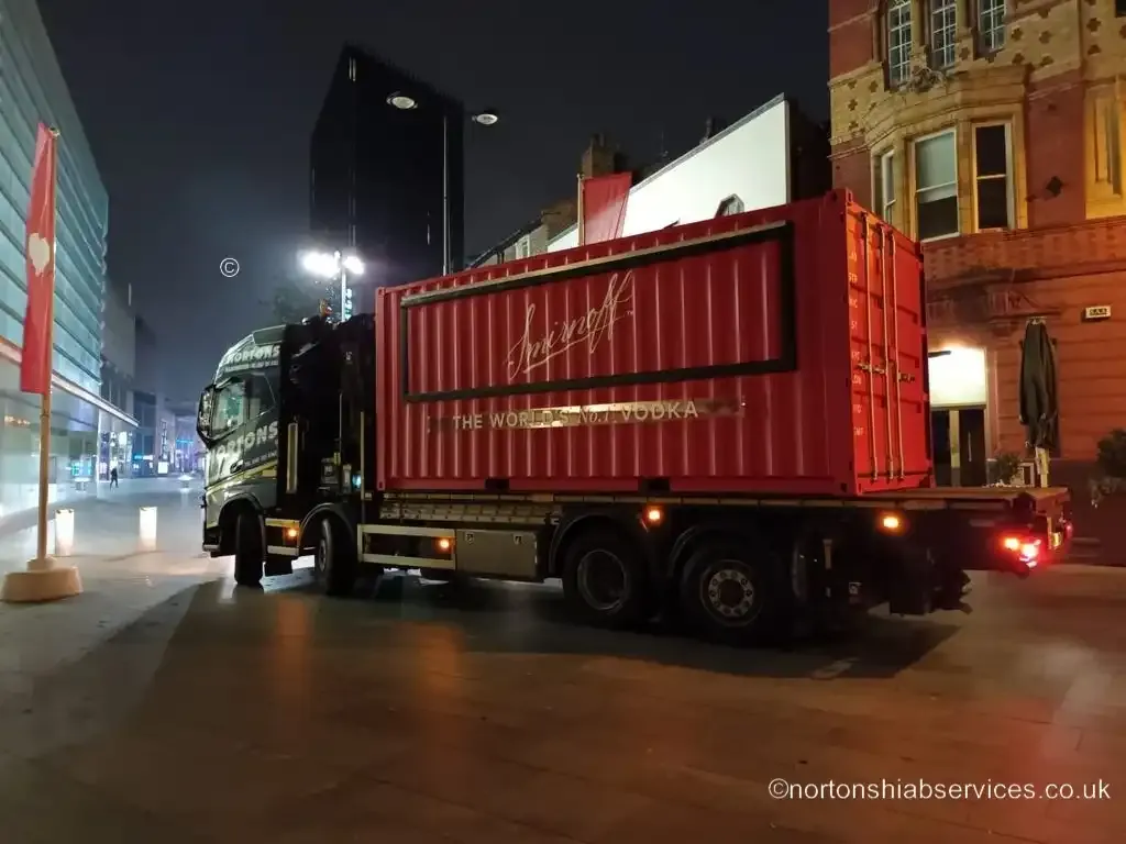 Nortons hiab lorry with a container in Liverpool city centre at night before a festival