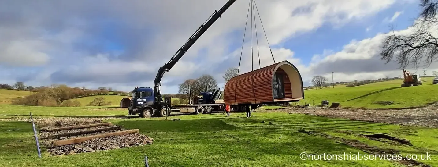 Glamping pods loaded and strapped on a Nortons trailer at the yard