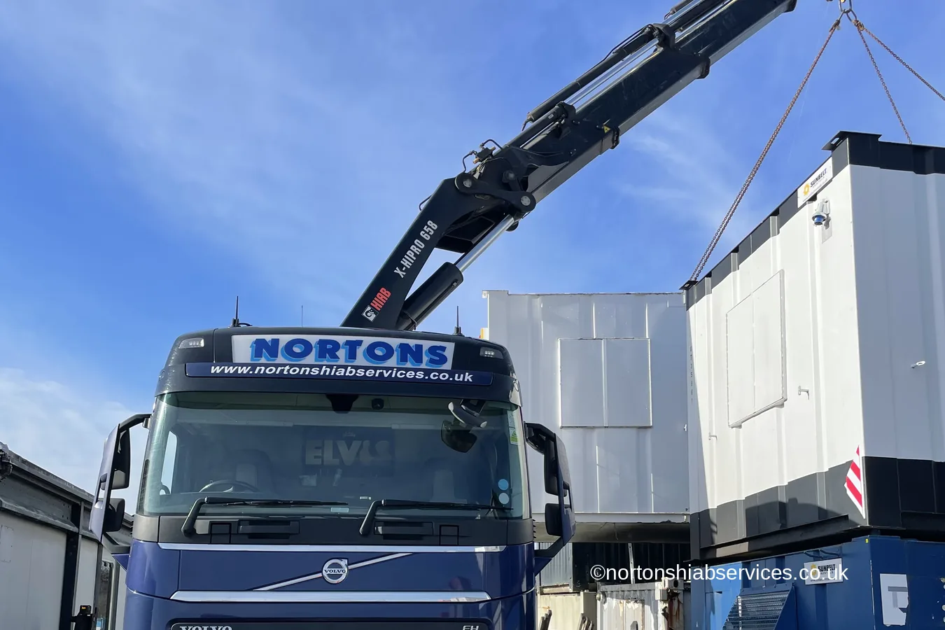 A Nortons 658 wagon and drag loaded with two portable cabins
