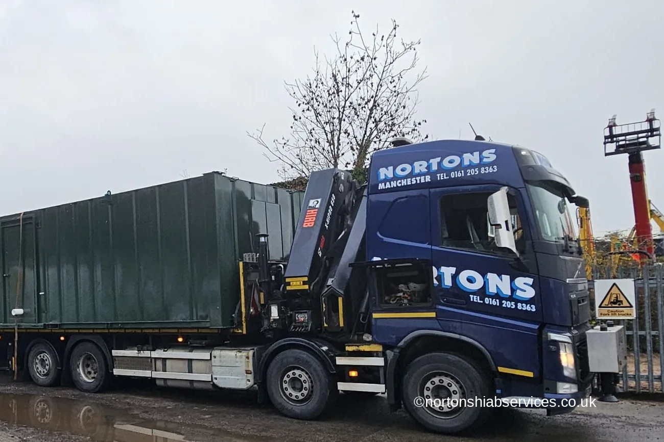 Green site cabins loaded on a Nortons wagon and drag for delivery to Droitwich