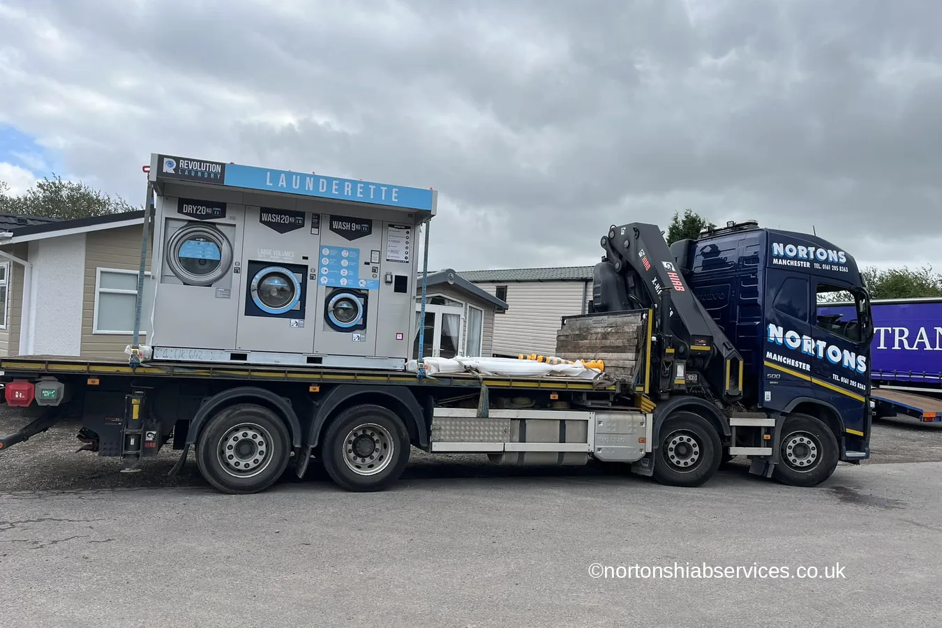 A refrigerated portable unit loaded on a Nortons rigid hiab