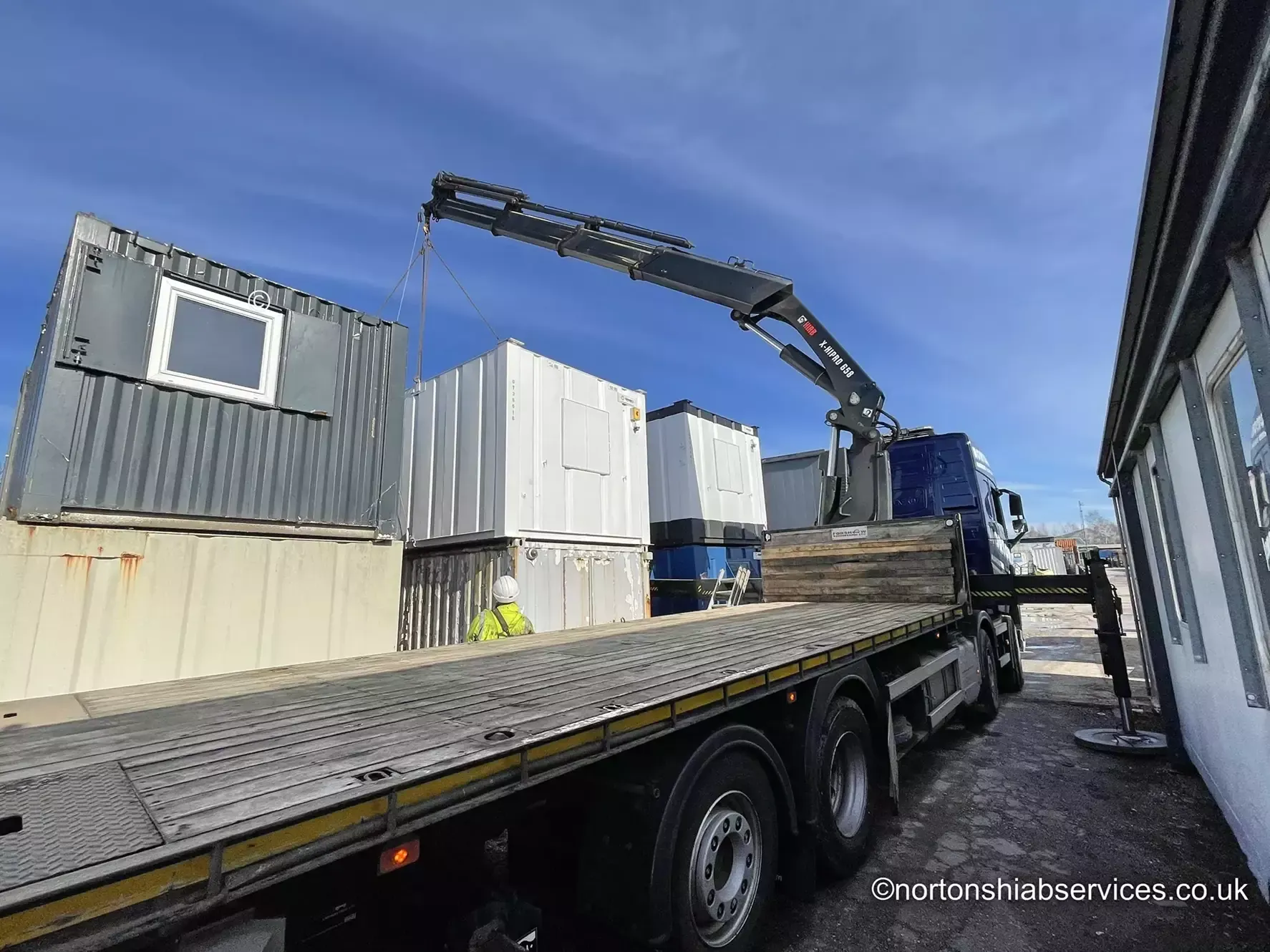 Nortons 658 hiab lifting a second portable cabin at a site set-up