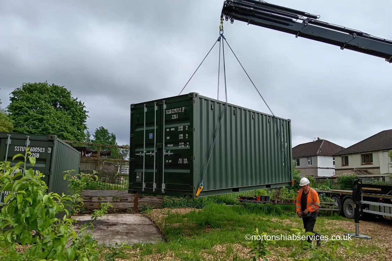 A green container placed on site for a community bike library