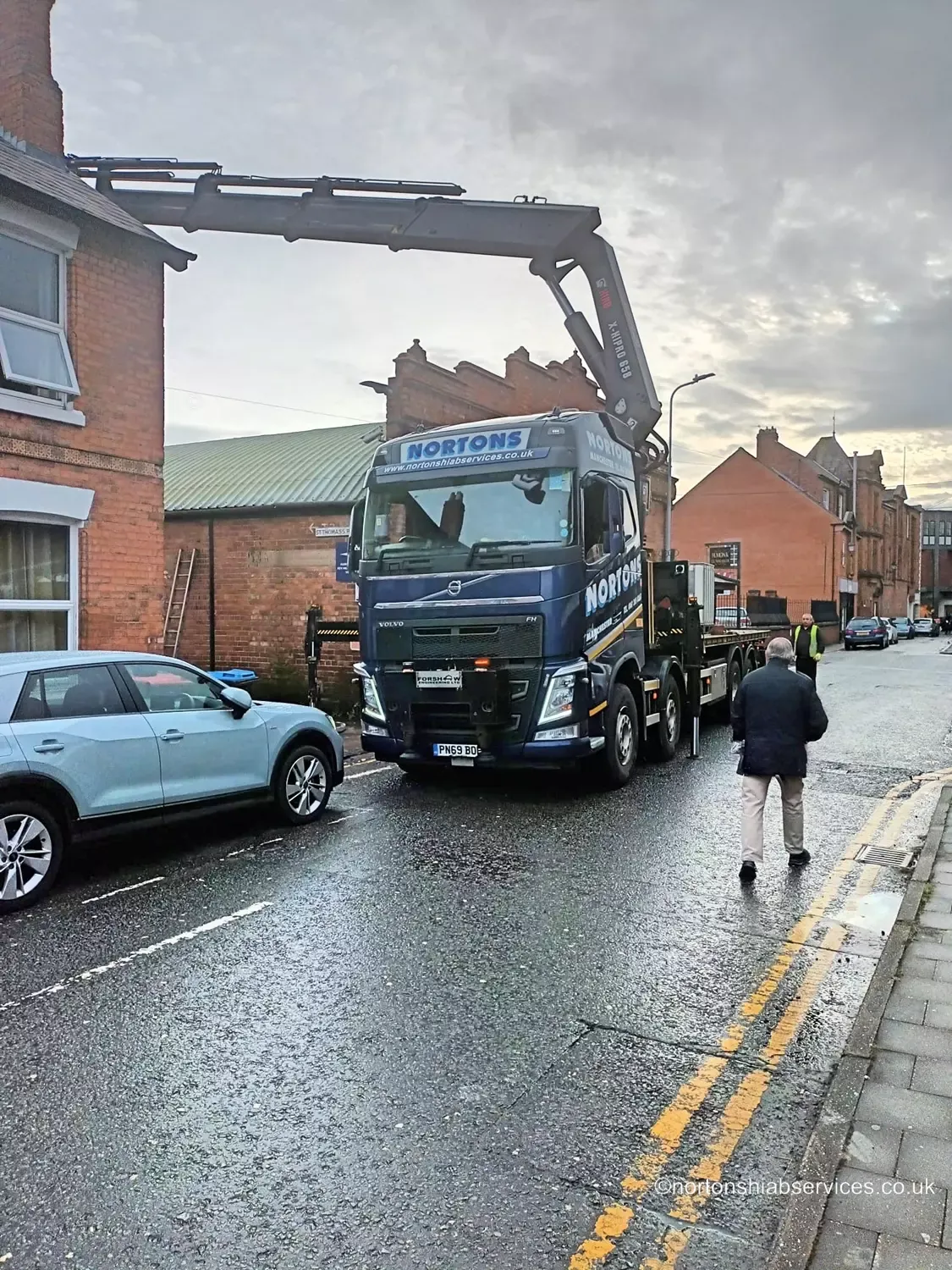 A Nortons rigid hiab set up on a narrow terraced street for a brewery lift