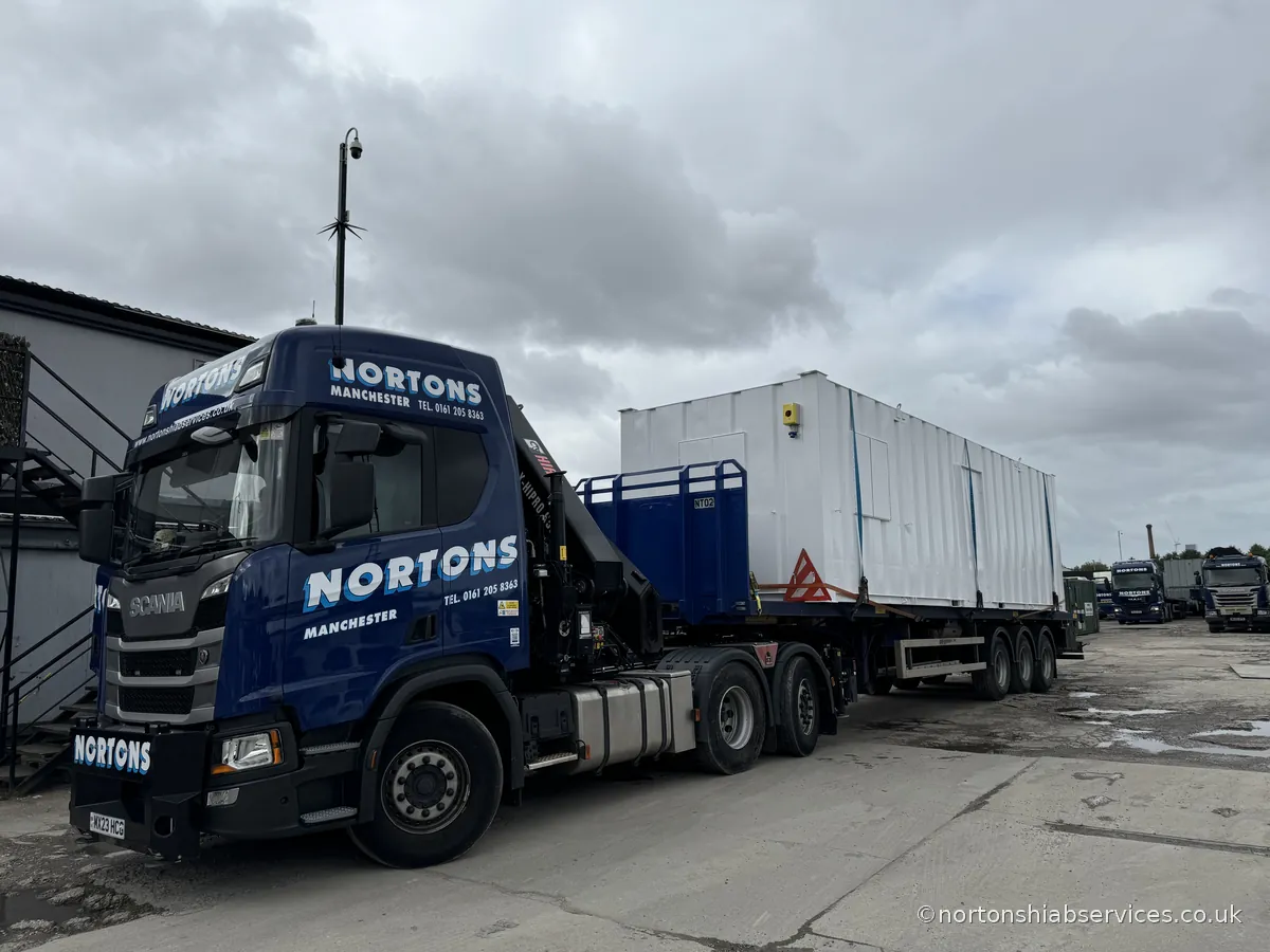 A fully refurbished portable cabin loaded on a Nortons trailer at the yard