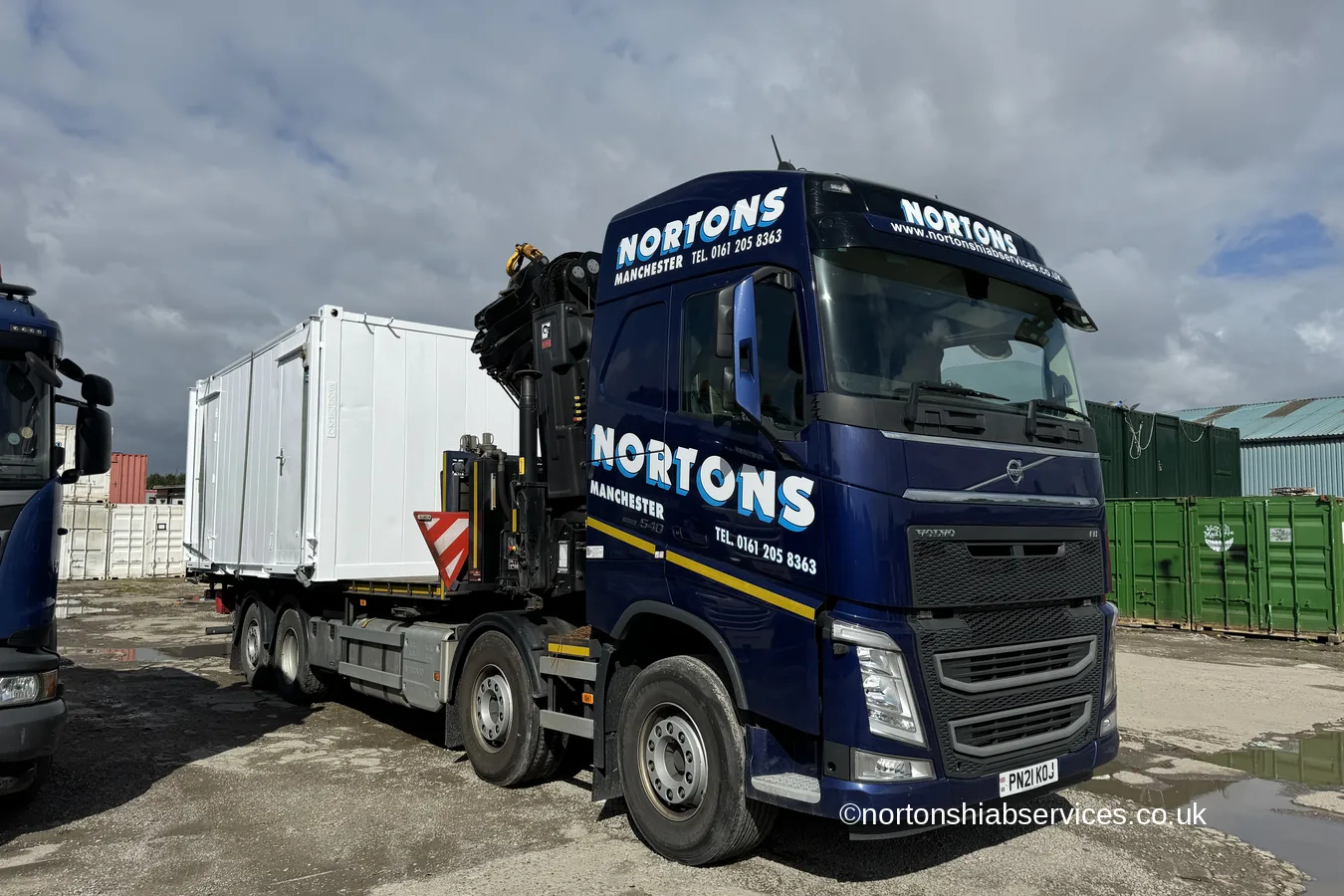 A fully refurbished portable cabin loaded on a Nortons hiab ready for delivery
