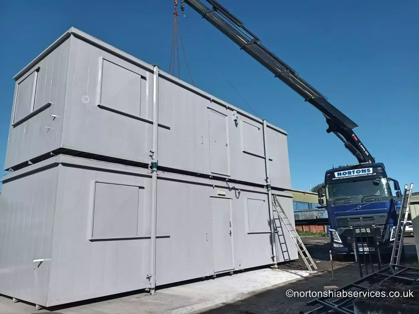 Two portable cabins delivered and double stacked by a Nortons hiab