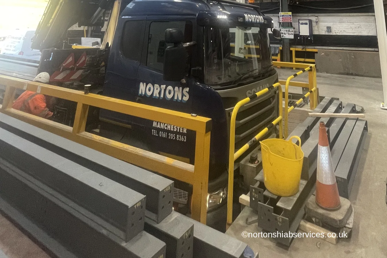 A Nortons 855 hiab working inside a building with steel beams on the floor