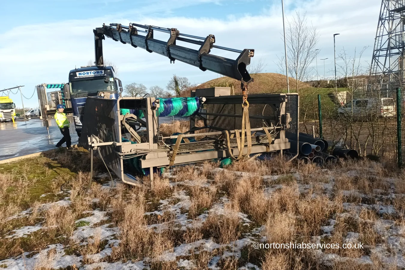 A Nortons rigid hiab lifting a commercial truck wash gantry into position at Lymm