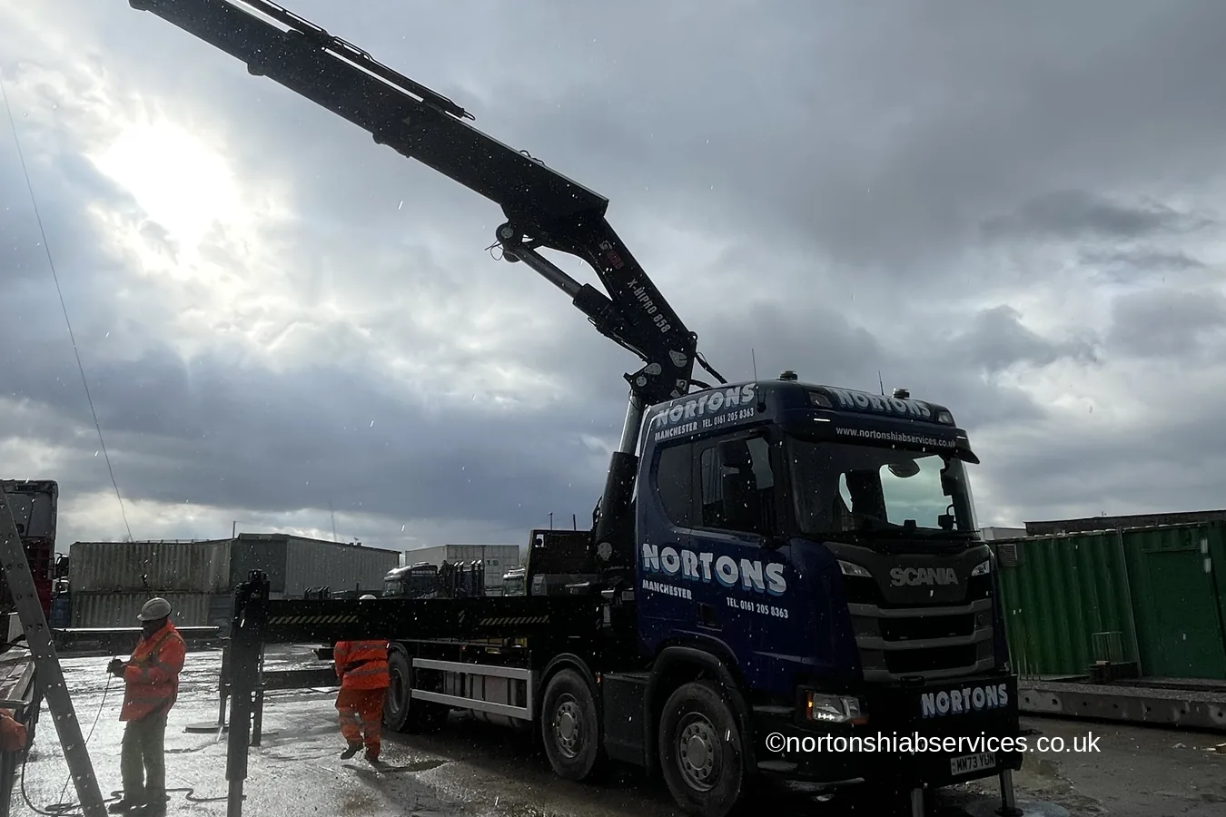 A Nortons 858 hiab lifting a precast concrete plank on slings
