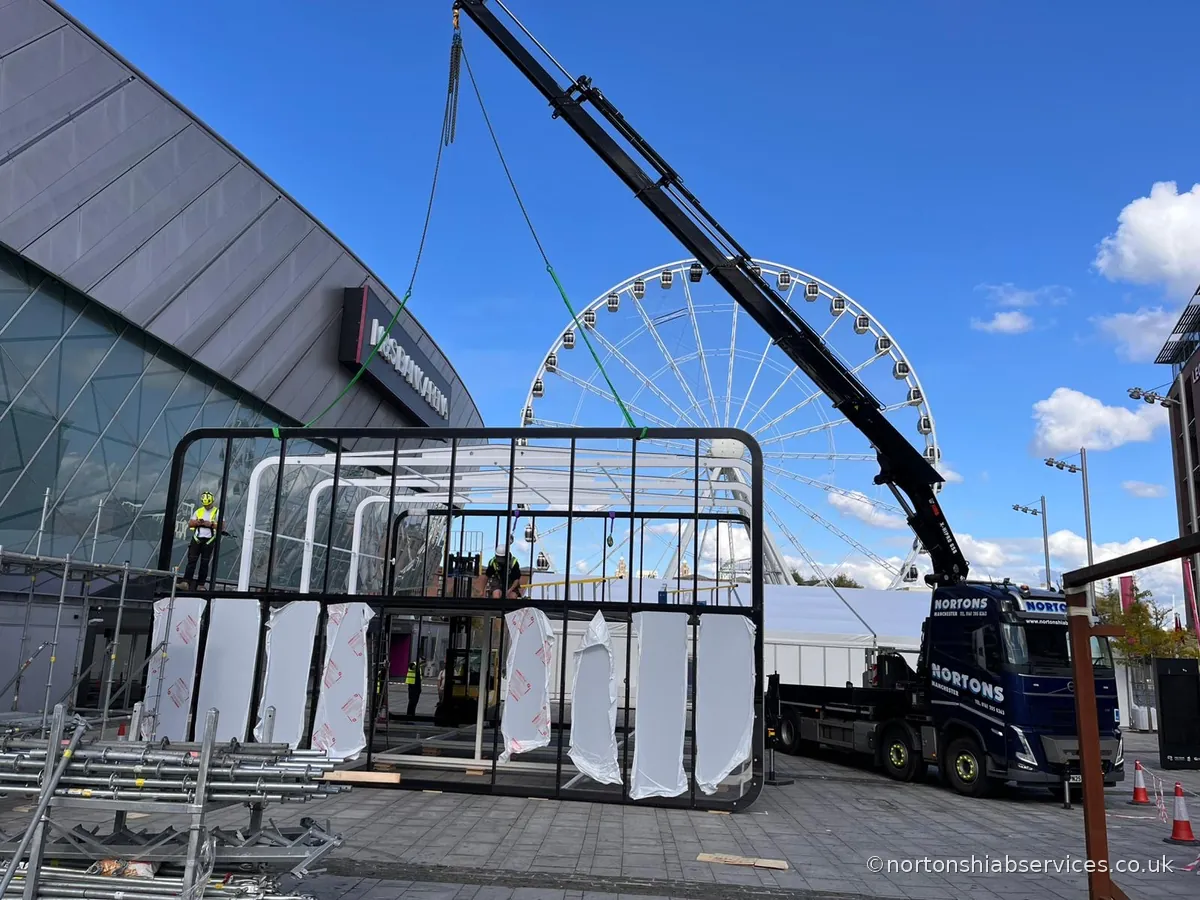 Nortons rigid hiab installing a large events marquee frame outside an arena on the Liverpool waterfront