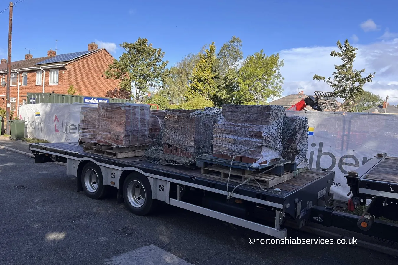 Wrapped panels loaded and strapped on a Nortons trailer at Ellesmere Port