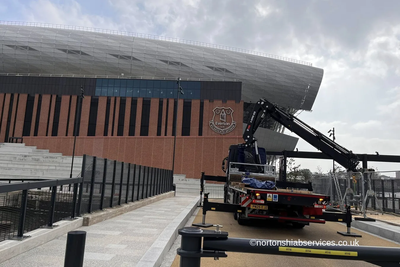 A Nortons hiab with its boom extended outside Everton's new stadium