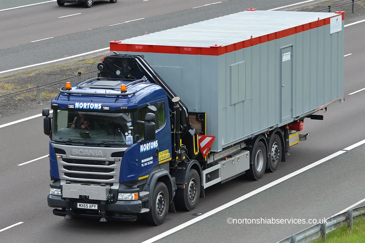 A Nortons hiab lorry carrying a cabin on the M74 at Greenhillstairs