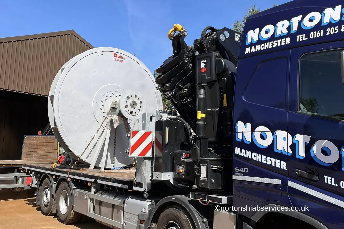A large cable drum loaded on a Nortons hiab lorry at Mold
