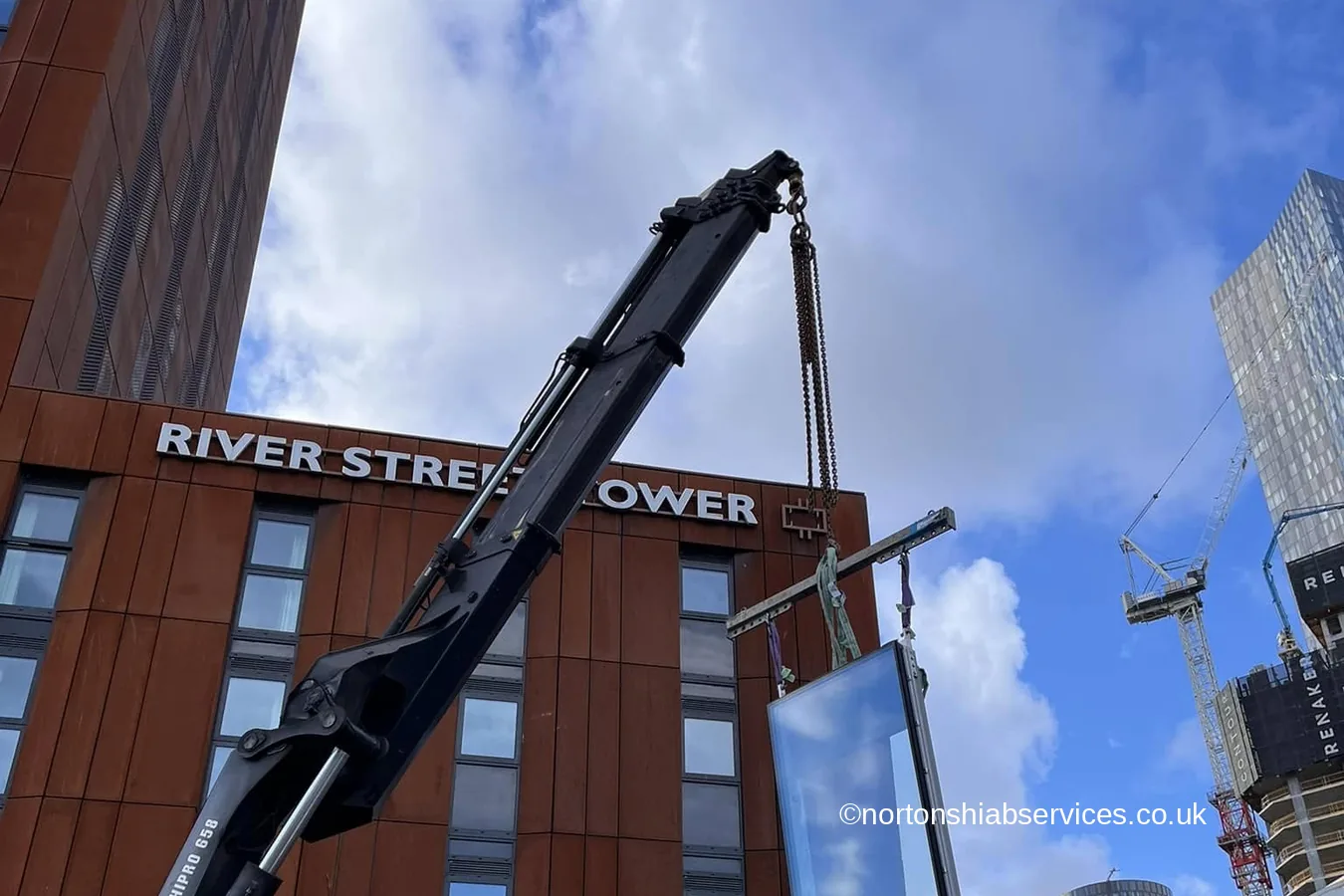A Nortons hiab working at the foot of River Street Tower in Manchester