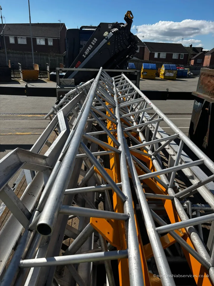 Lengths of aluminium truss section loaded and strapped on a Nortons lorry in Liverpool