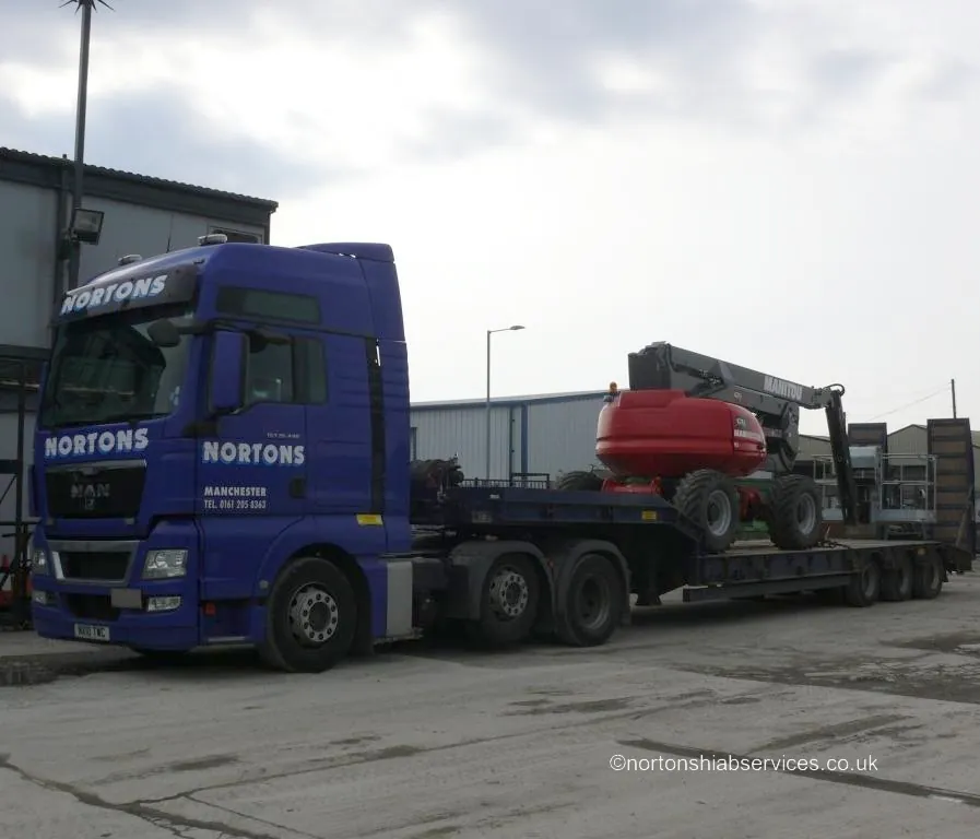 Boom lift loaded on a Nortons lorry for transport