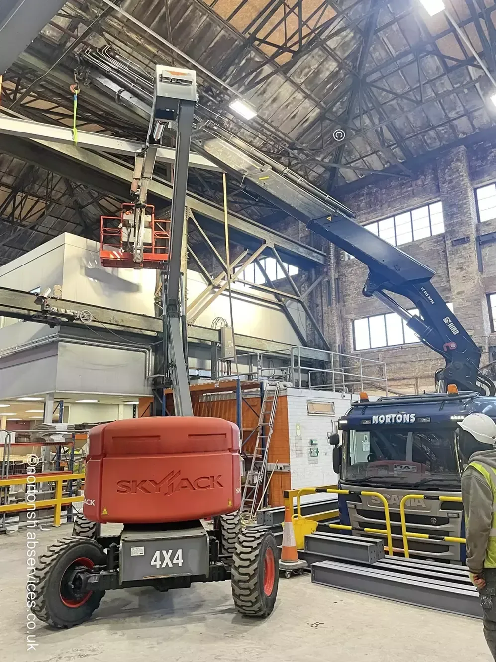 Telehandler inside a warehouse being prepared for transport by Nortons