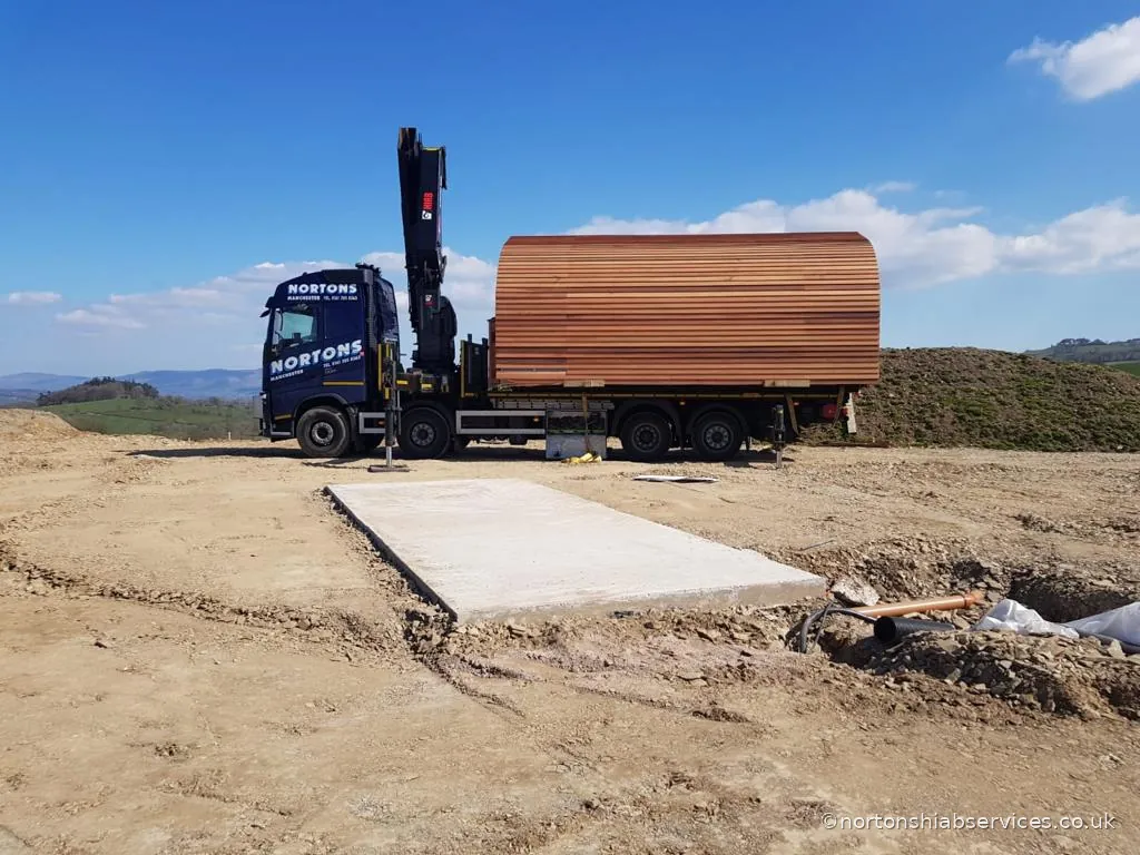 Glamping pod being positioned on site by a Nortons hiab