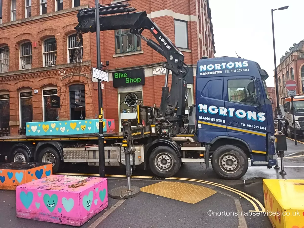 Concrete bollard being lifted from a Nortons lorry