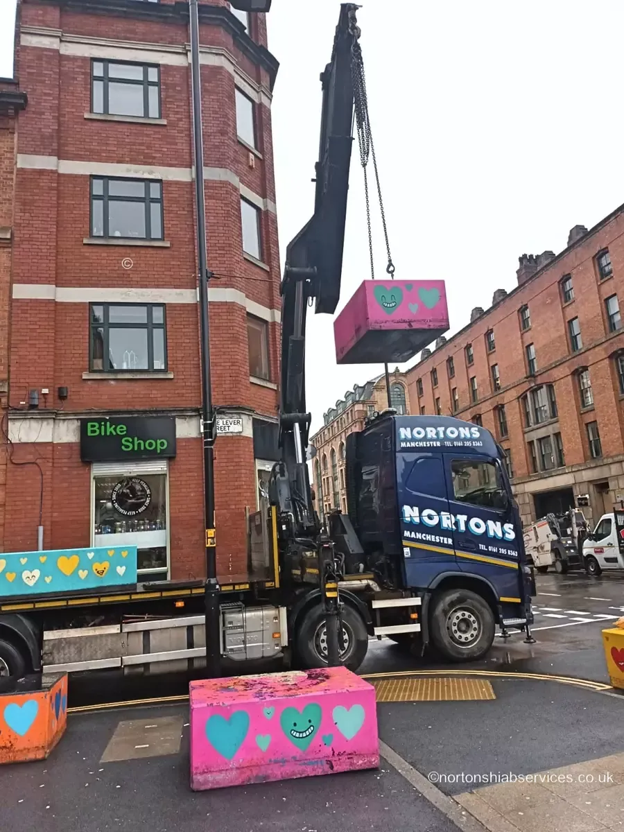 Concrete bollard being set down on its mark
