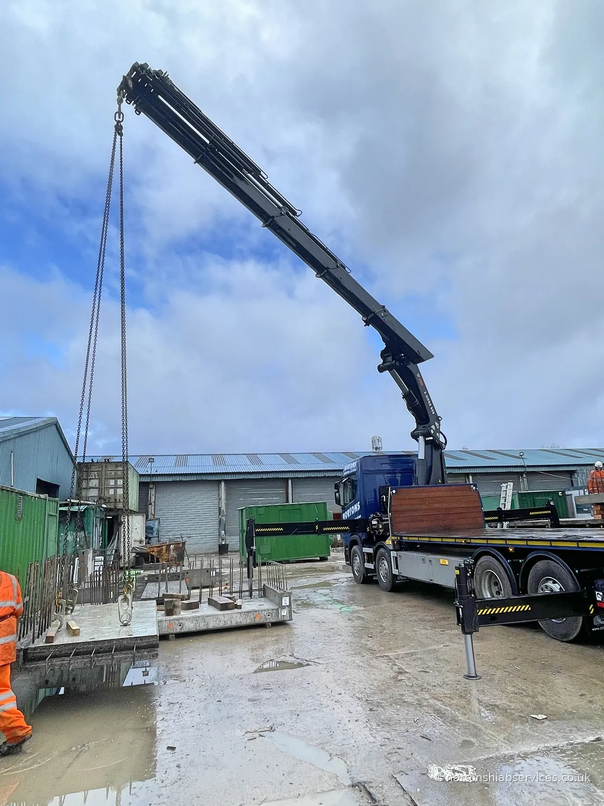 Precast unit being guided into its final position