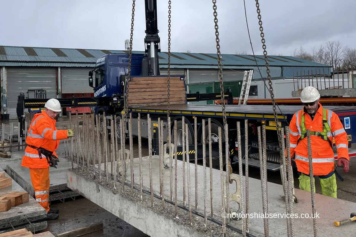 Precast concrete unit landed on timber packing between starter bars
