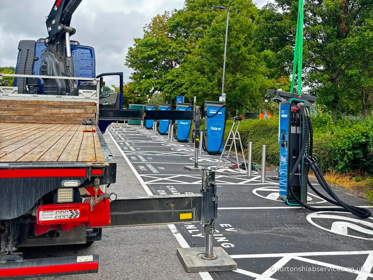 A row of EV rapid charging units installed at a charging hub by a Nortons hiab