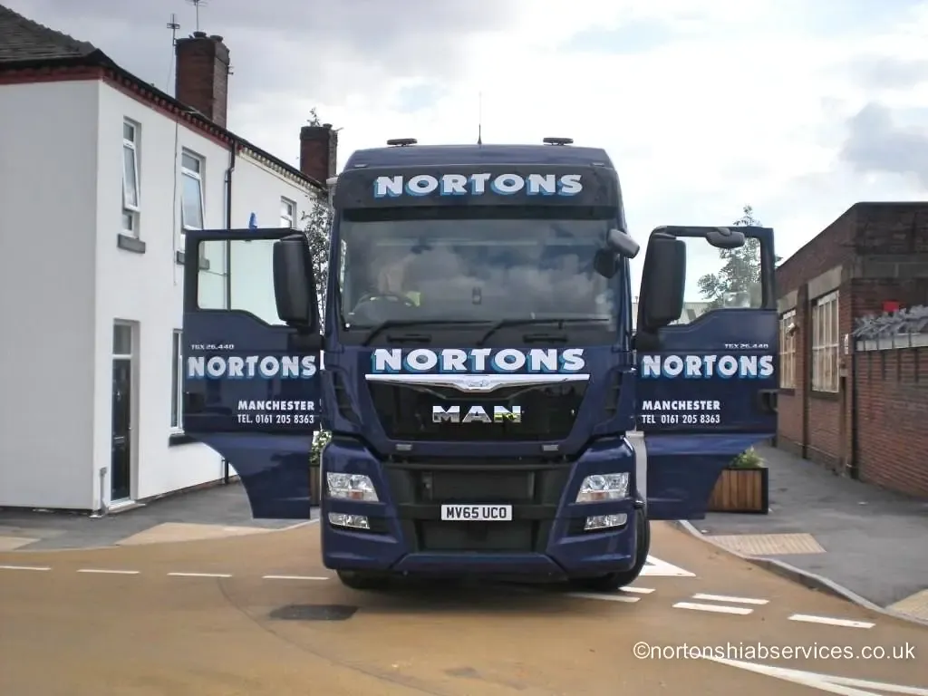 A Nortons MAN tractor unit standing on the renovated terraced street at Canada Street, Manchester