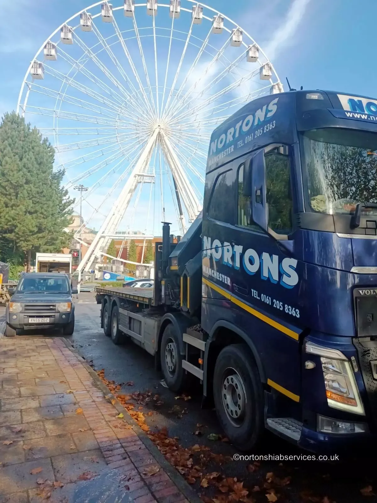 A Nortons hiab lorry at work lifting a load on site