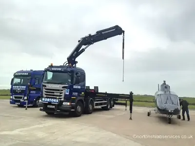 Nortons hiab with the crane set and the stabiliser legs down on the airport apron