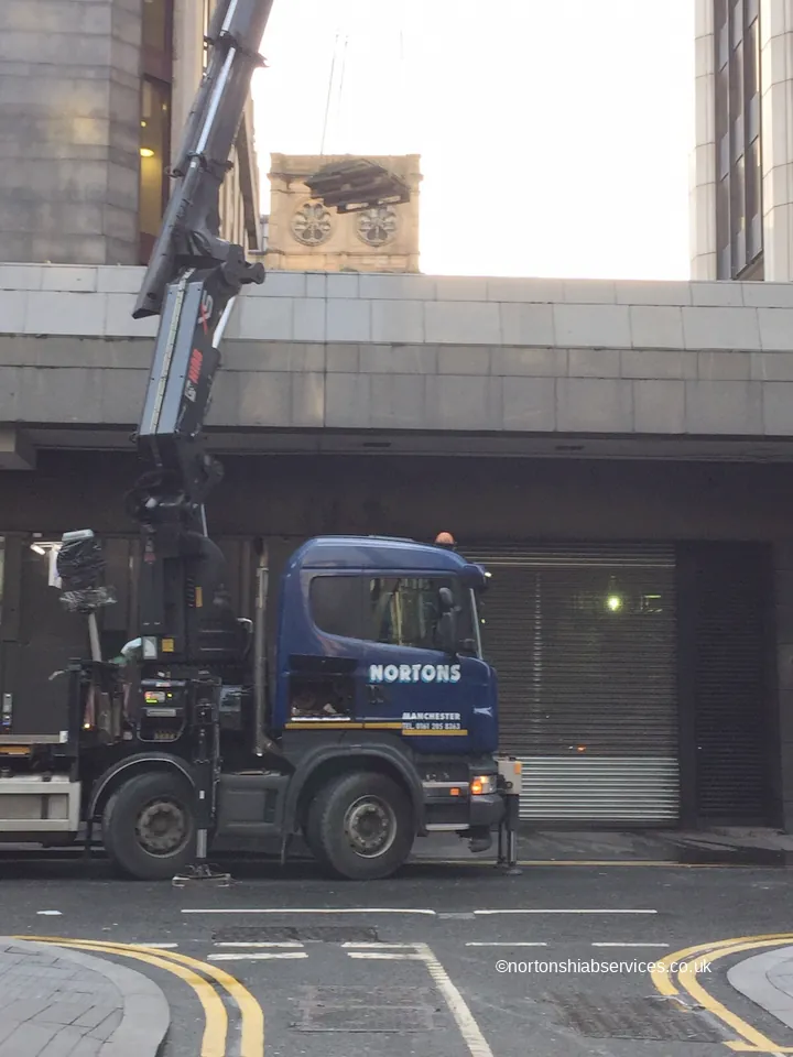 Nortons hiab with outrigger legs set down on a city footway