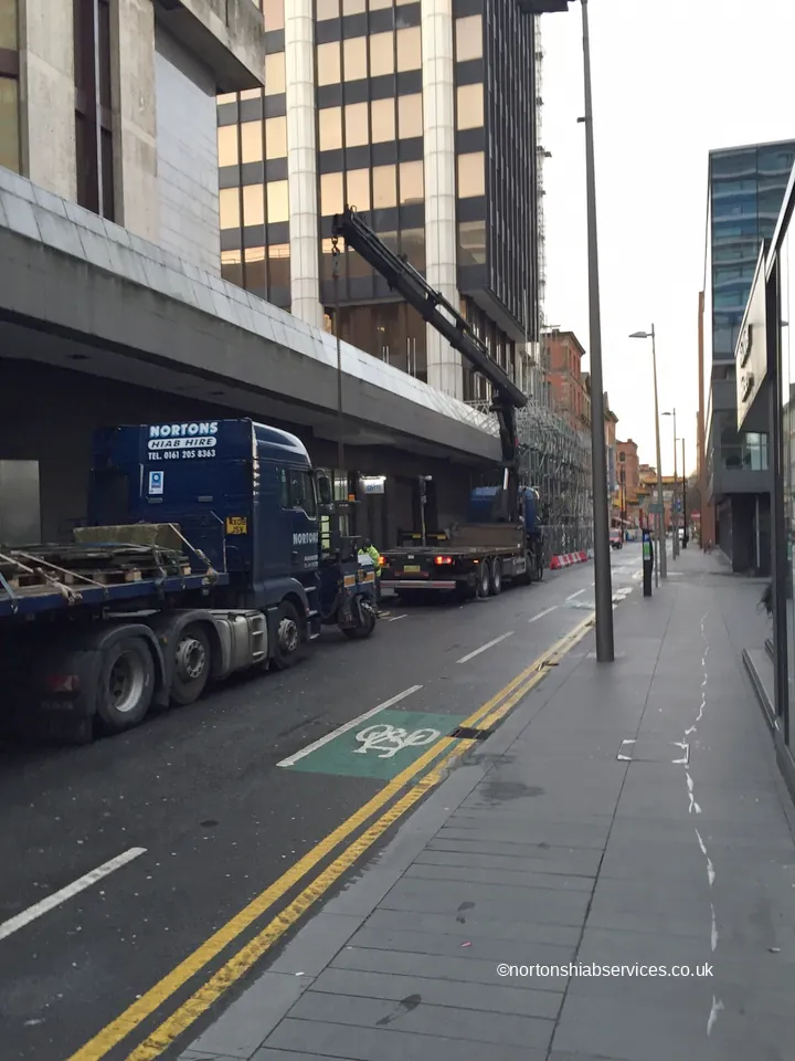 Paving slabs lifted from a rooftop by a Nortons hiab