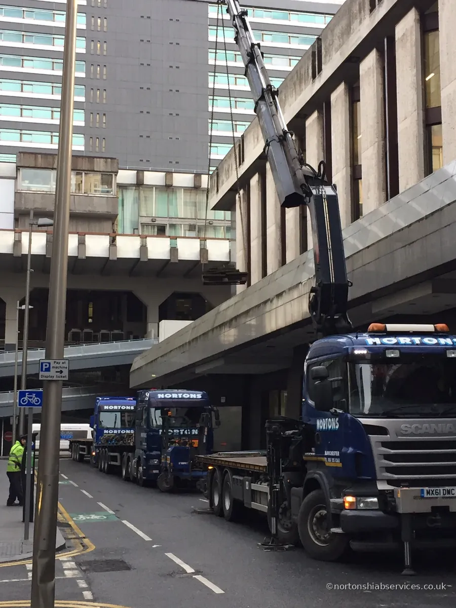 Street-level view of a Nortons hiab working against a city building
